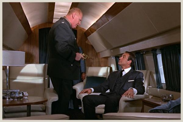 Goldfinger confronts Bond on the plane